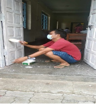 A man painting door with white color