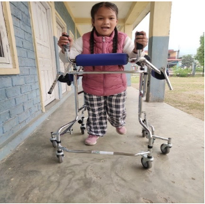 A young girl utilizing a four-wheeled mobility aid for support.